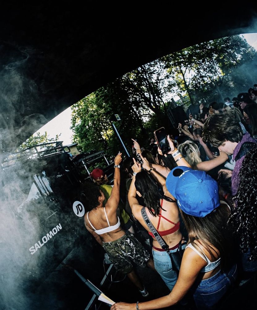 The crowd dancing beside the Salomon and JD branded stage vehicle